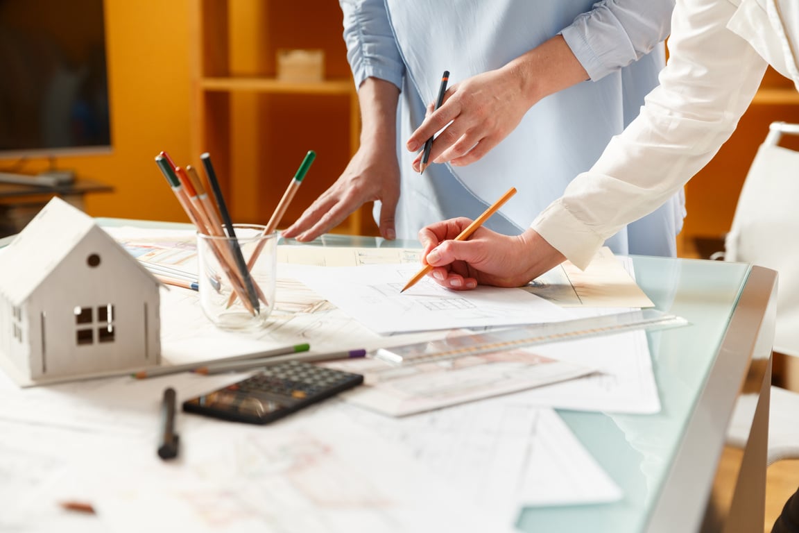 Interior designers working on hand drawings of  interior at work place